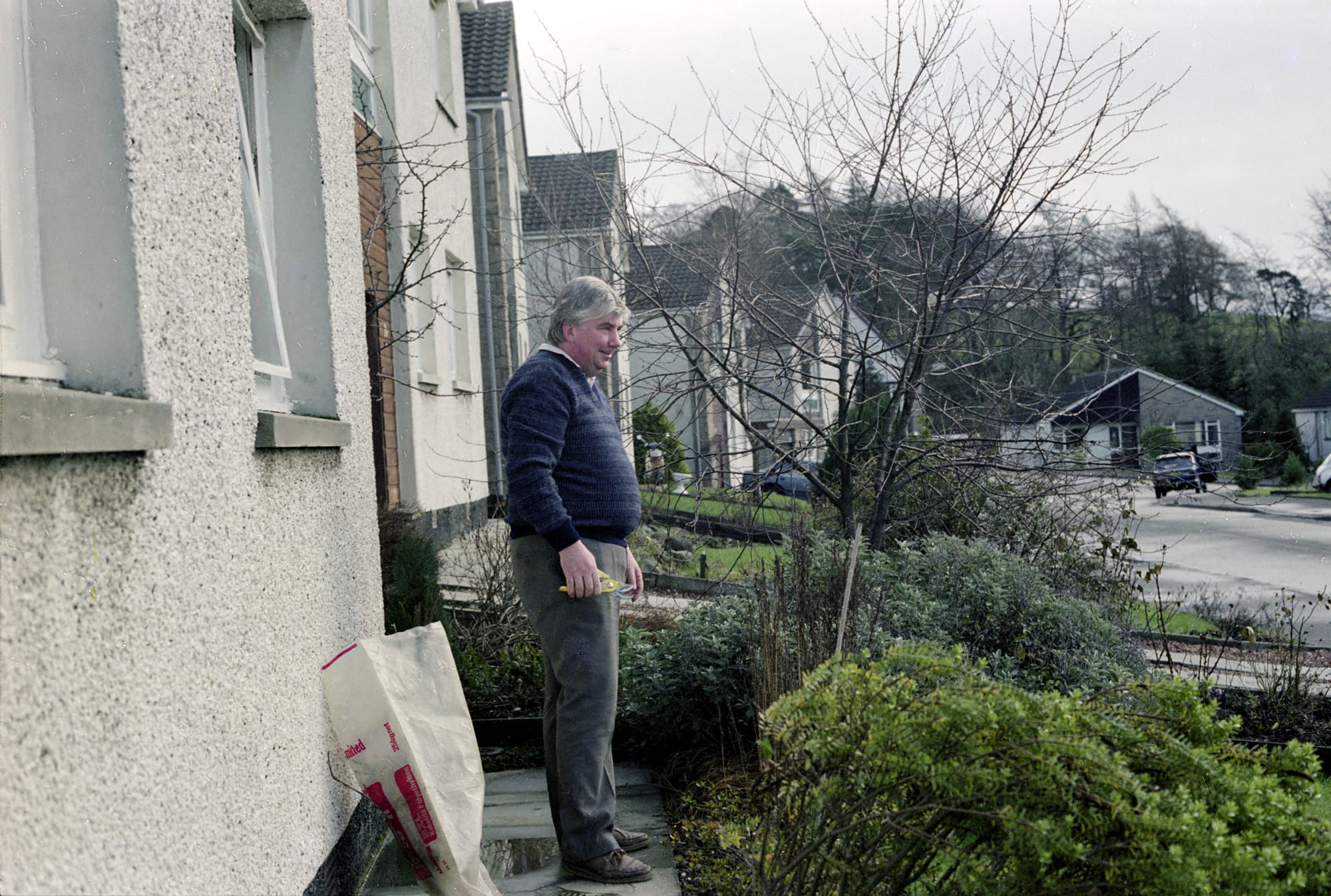 Roy Tinworth gardening in Dollar in February 1983